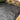 Black landscape fabric with grid pattern on a garden bed
