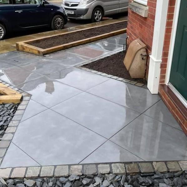 shiny grey porcelain paving front garden