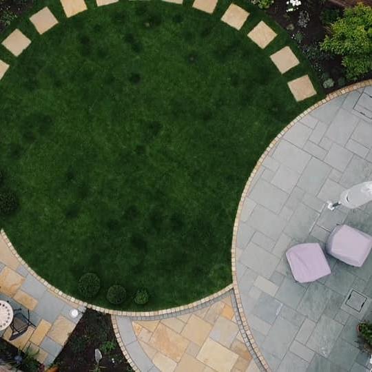 birds eye view of garden project with turf and aqua blue limestone paving and yellow paving stepping stones
